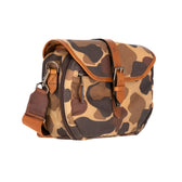 Tom Beckbes Classic Camo Blind Bag features a camo pattern, leather-bound top, brown strap, and double-shell pockets.