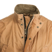 Tom Beckbe Kinsman Vest in tan: stand-up collar, weatherproof, front zipper & snaps, two pockets; shoulder view shown.