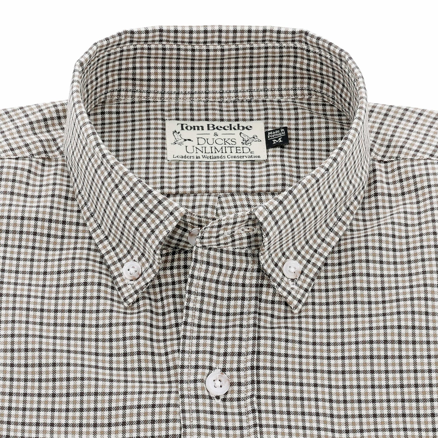 Close-up of the Tom Beckbe Knapp Cotton Twill Shirt in brown, beige, and white plaid with Ducks Unlimited label inside.