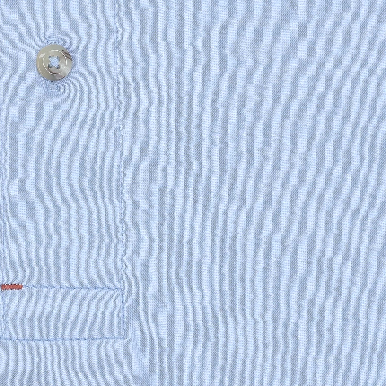 Close-up of the Benton Polo Shirt by Tom Beckbe, a classic fit men’s polo in light blue Pima cotton with button and pocket.