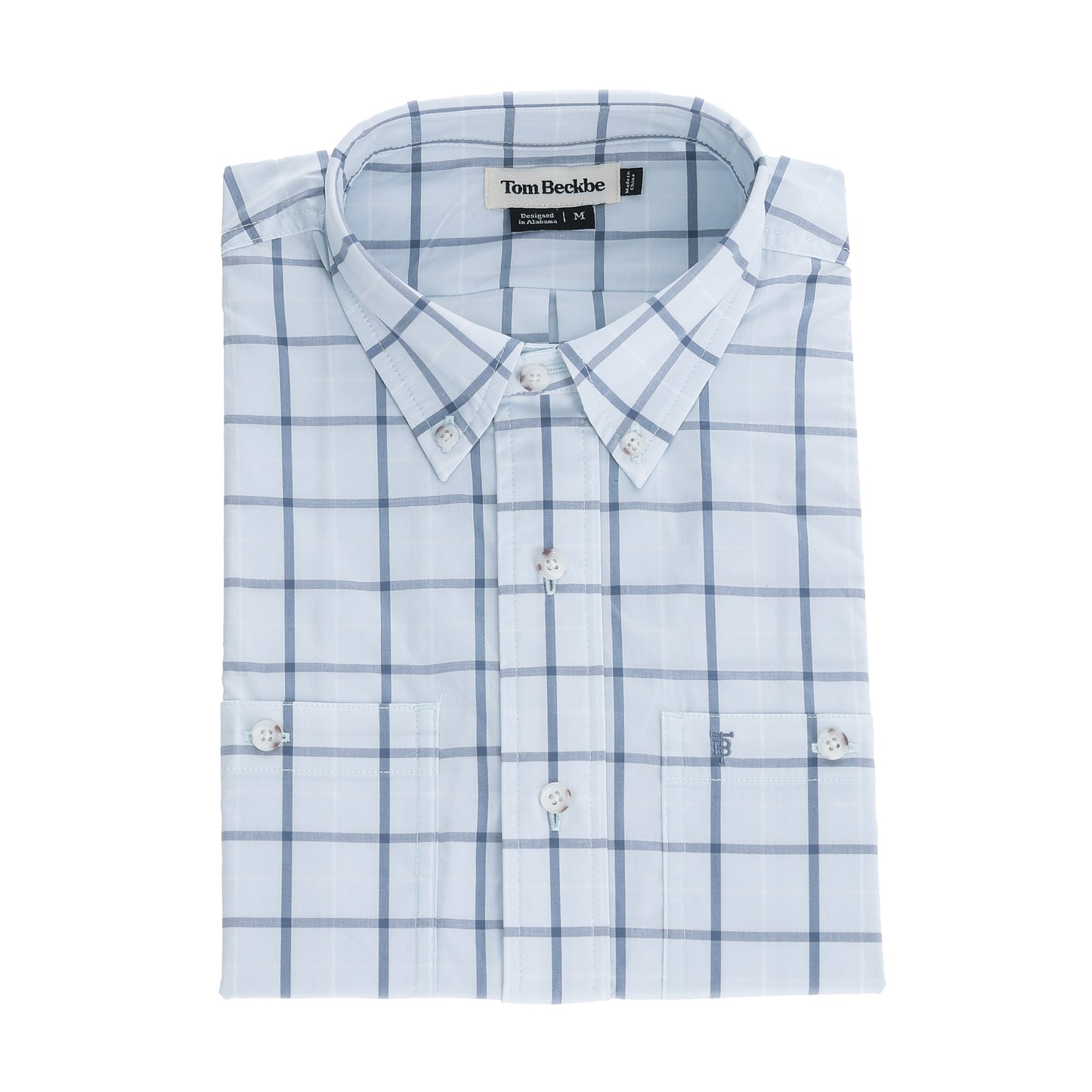 A neatly folded light blue checkered Tom Beckbe Tidewater Shirt with visible branding on the long sleeve.