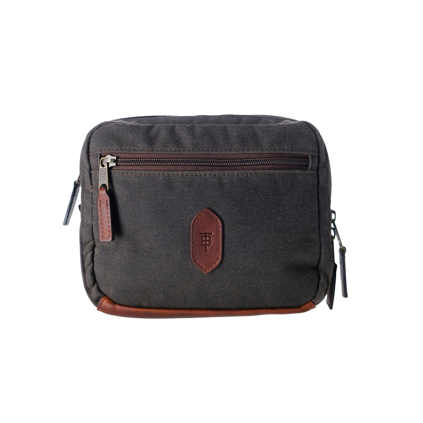 A Tom Beckbe black waxed canvas toiletry bag with brown leather accents and front zip, shown on a white background.