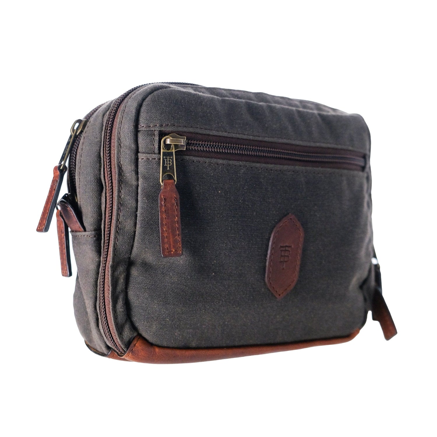 Tom Beckbes Canvas Hanging Toiletry Bag with leather accents, a zip pocket, side loop, and visible seams.