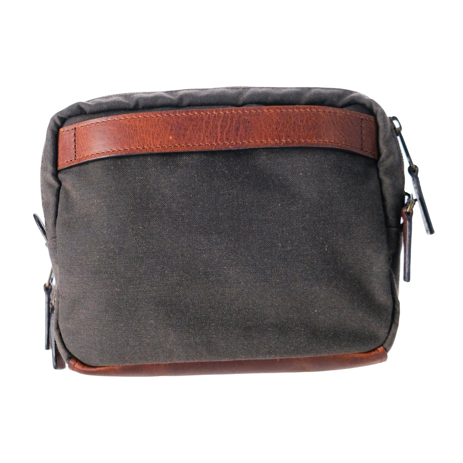 A Tom Beckbe Canvas Hanging Toiletry Bag with brown leather accents, zippers, on a white background.
