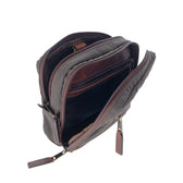 Unzip the Canvas Hanging Toiletry Bag by Tom Beckbe to reveal multiple compartments and zippers inside.