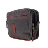 Tom Beckbes brown waxed canvas and leather crossbody bag has two zippers, a front pocket, and leather accents.
