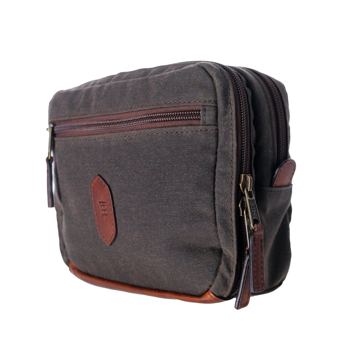 Tom Beckbes brown waxed canvas and leather crossbody bag has two zippers, a front pocket, and leather accents.