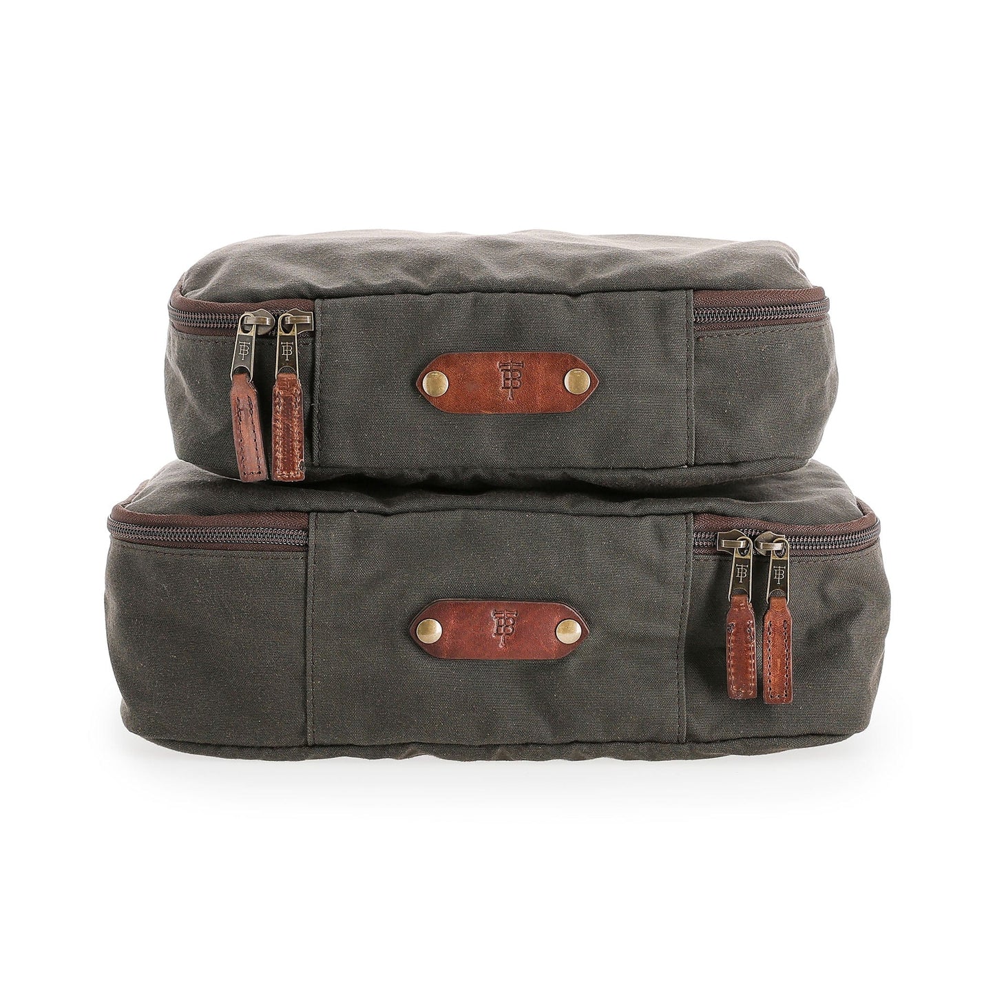 Stacked dark gray Canvas Packing Cubes by Tom Beckbe, crafted in waxed cotton canvas with brown leather accents.