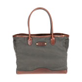 A Tom Beckbe green waxed Canvas Tote with leather handles on a white background.