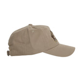 Side view of Tom Beckbe’s “The Flush” beige cotton twill 5-panel hat with strap and front embroidery.