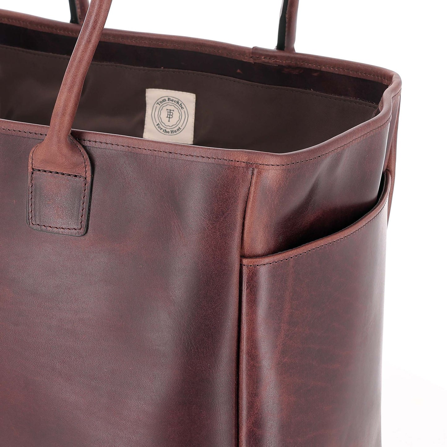 A close-up of the Tom Beckbe Covington Leather Carryall Bag featuring a waterproof interior.