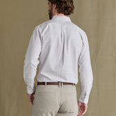 Man in a Tom Beckbe Culver Oxford Shirt and beige pants stands with his back to the camera.