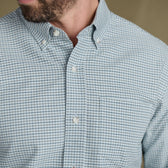 Man wearing Tom Beckbe Culver Oxford Shirt in light blue, breathable fabric with front pocket, shown neck to chest.