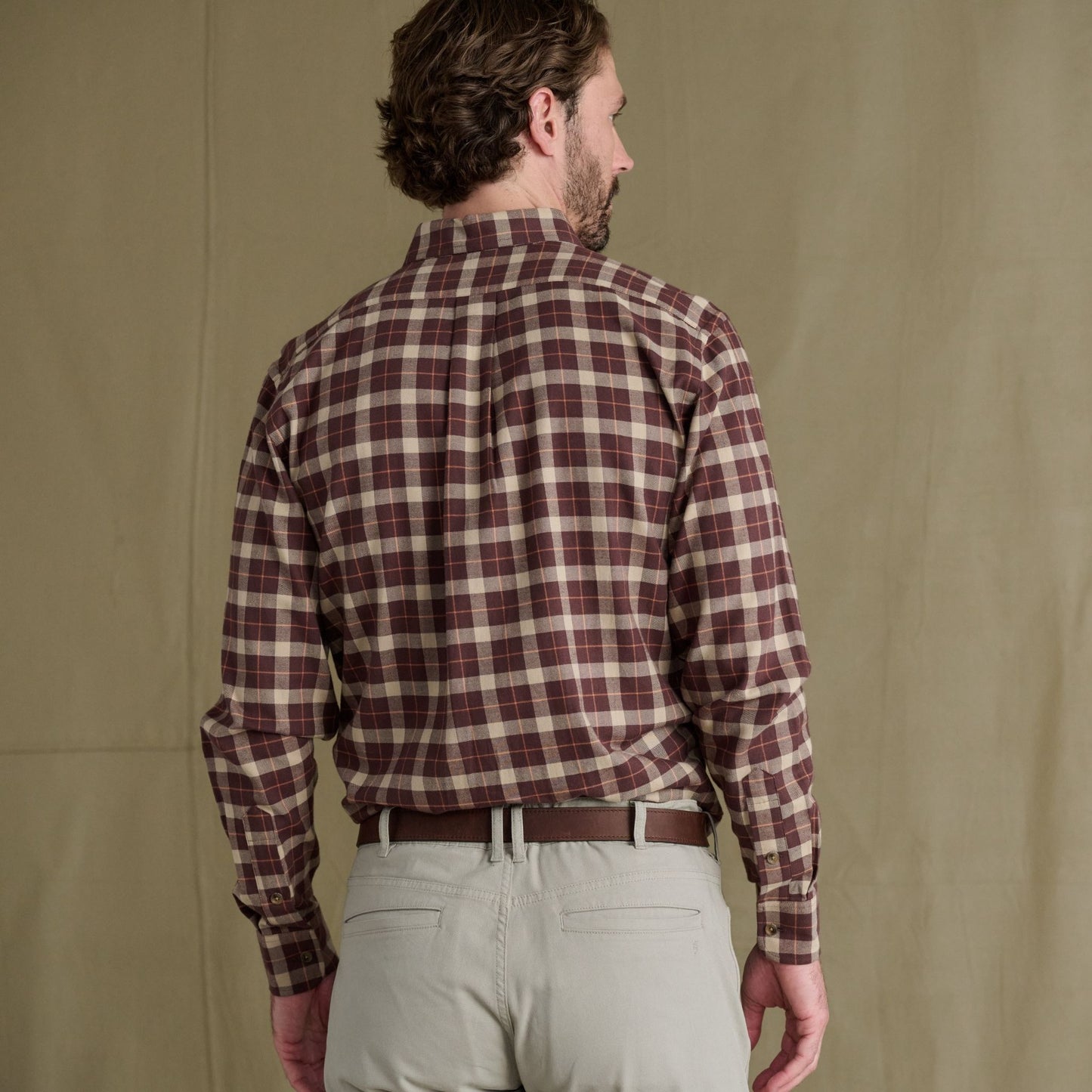 Man facing away, wearing a maroon and beige Tom Beckbe Dixon Brushed Cotton Twill Shirt with gray pants and brown belt.