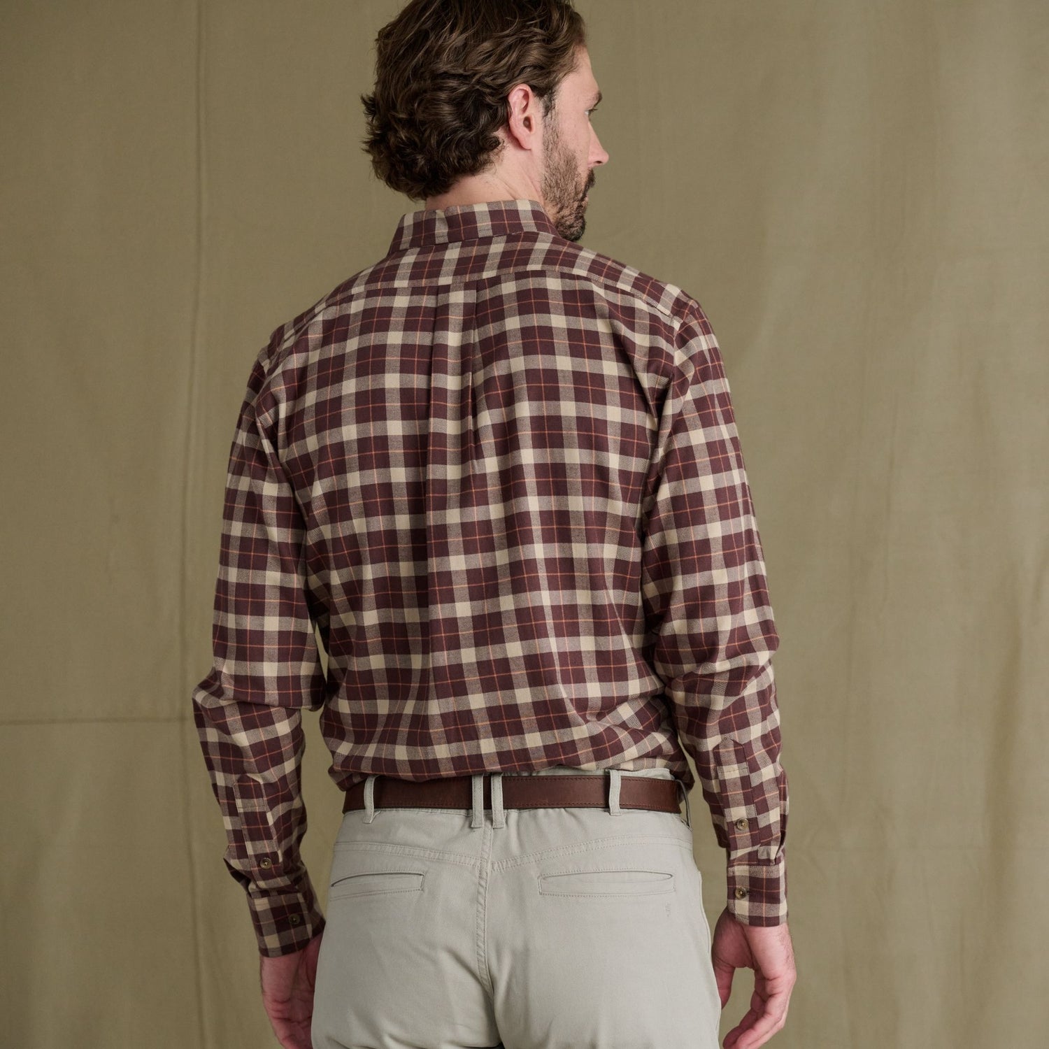 Man facing away, wearing a maroon and beige Tom Beckbe Dixon Brushed Cotton Twill Shirt with gray pants and brown belt.