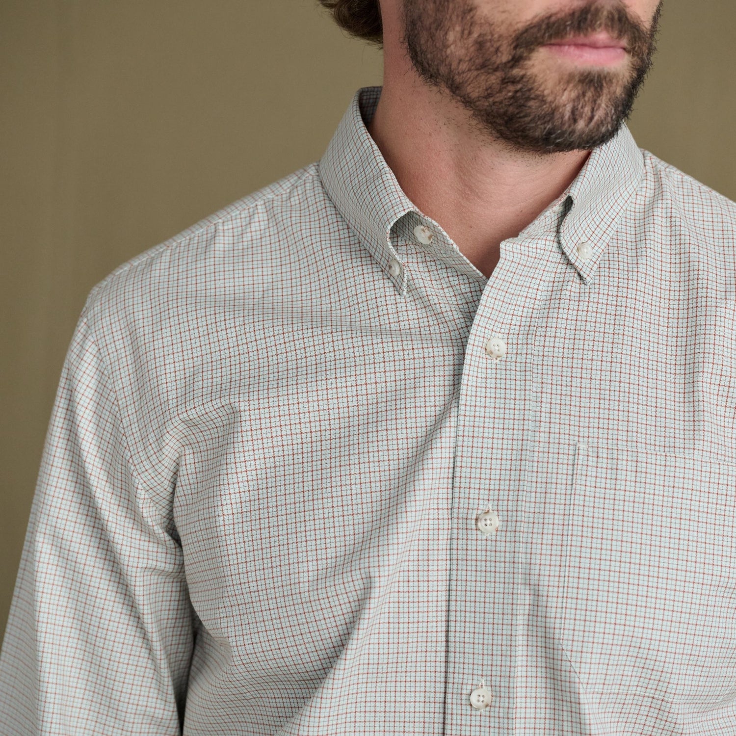 Bearded man in Tom Beckbe Ensley Pinpoint Oxford Shirt, light checkered cotton, against a plain background.