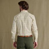 Man seen from behind in a Tom Beckbe Ensley Pinpoint Oxford Shirt, green pants, and a brown belt.