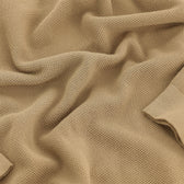 Tom Beckbe Foley Pima Crewneck Sweater in beige knit with textured pattern, folds, and ribbed cuffs.