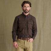 Man wears Tom Beckbe Hartwell Moleskin Shirt with tan pants, standing in front of a plain beige backdrop.