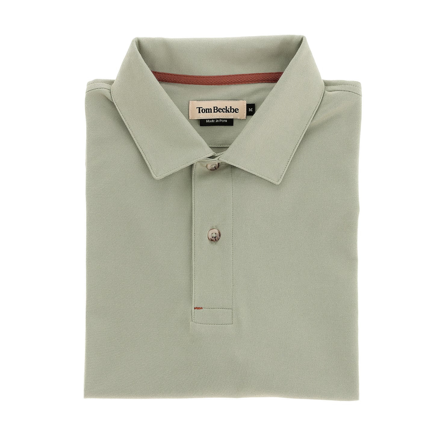 Hutton Performance Polo by Tom Beckbe in sage green, two-button, folded, shown on a white background.
