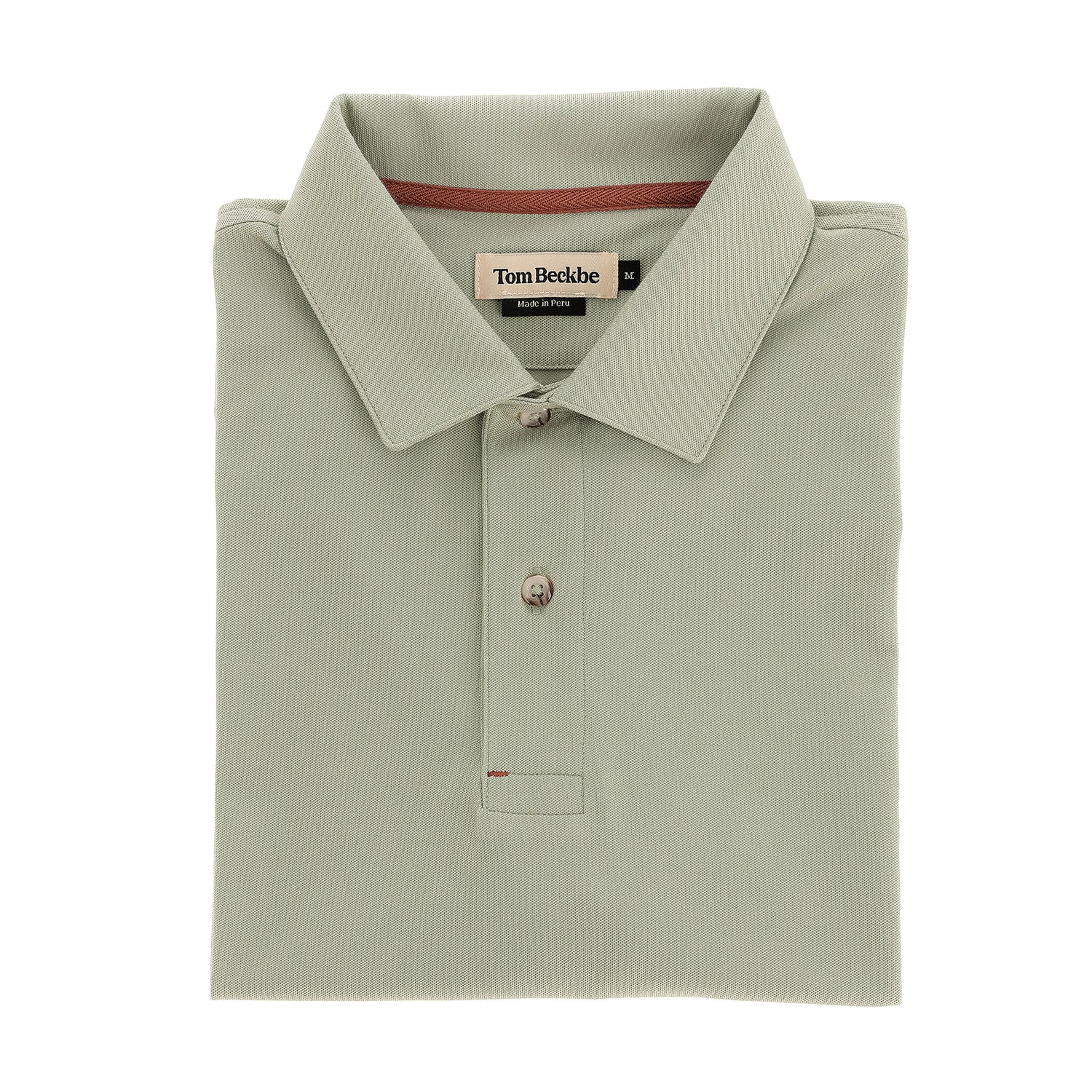 Hutton Performance Polo by Tom Beckbe in sage green, two-button, folded, shown on a white background.