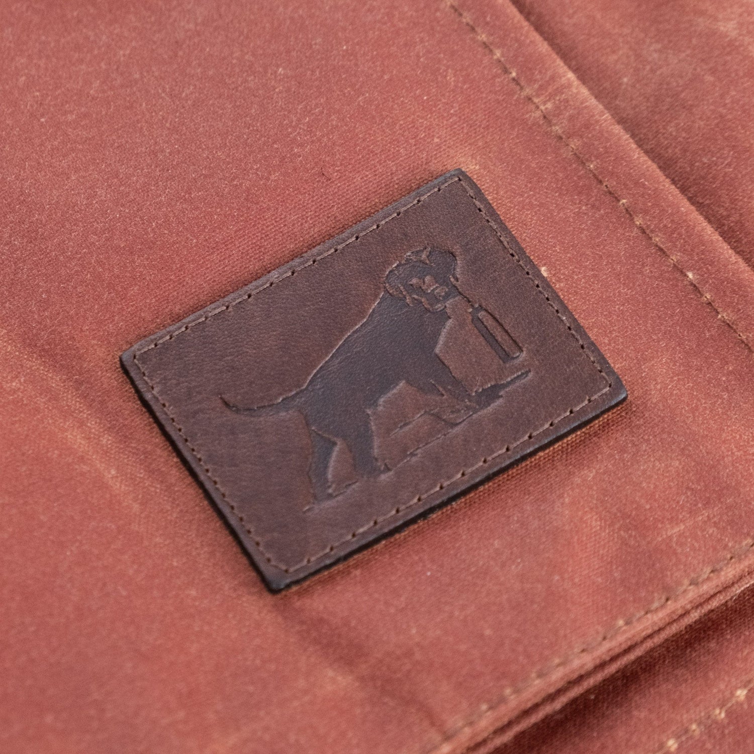 Limited edition Fox Red Kinsman Vest in brown fabric with a leather patch featuring an embossed dog holding an item.