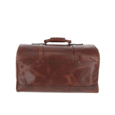 The Tom Beckbe Leather Weekender Duffel Bag in brown leather is shown from the front against a white background.
