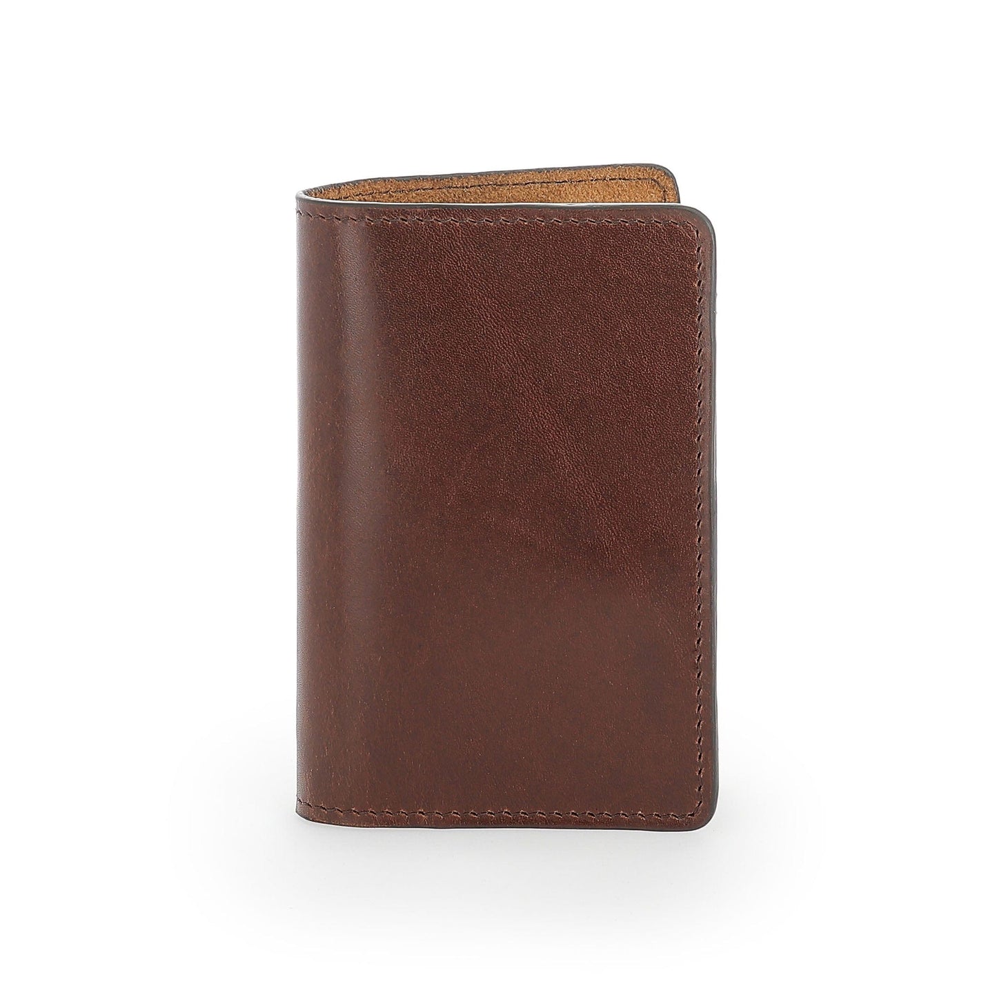 A Tom Beckbe Leather Passport Wallet in brown stands upright, its full-grain leather edges sharp against a white background.