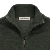 Close-up of a dark green Tom Beckbe York Merino Quarter Zip sweater with label visible at neckline.