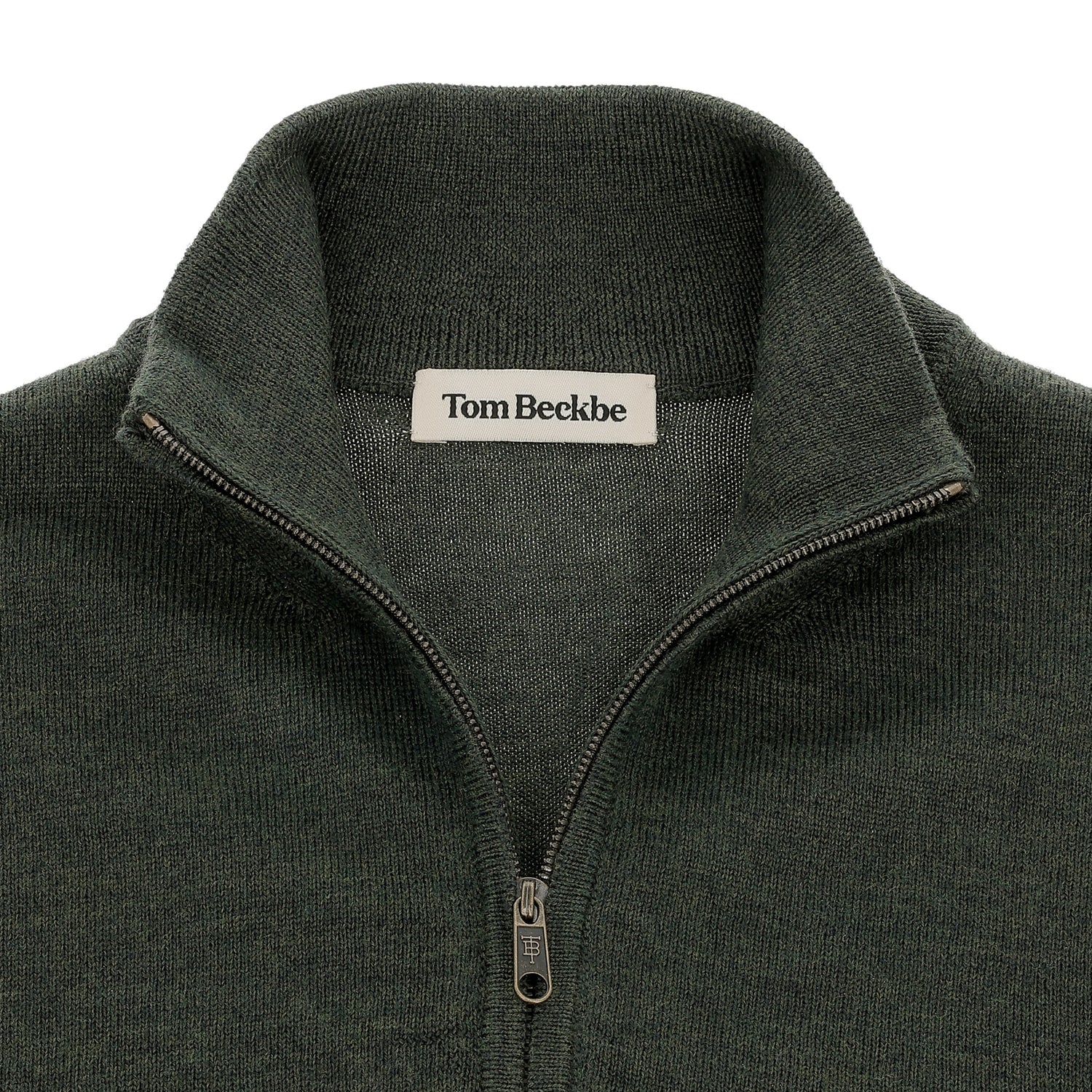 Close-up of a dark green Tom Beckbe York Merino Quarter Zip sweater with label visible at neckline.