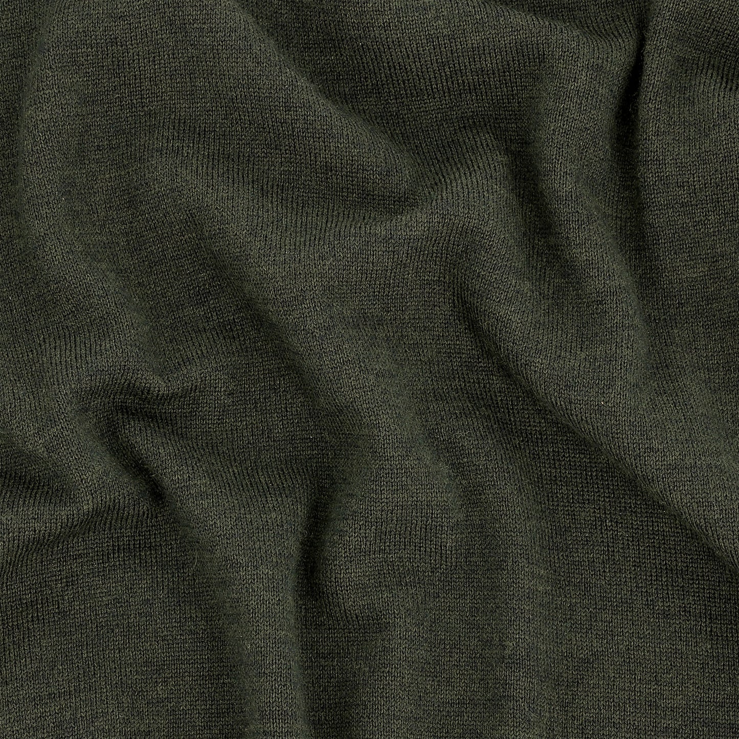 Close-up of the Tom Beckbe York Merino Quarter Zip in dark green, highlighting its soft texture and visible folds.