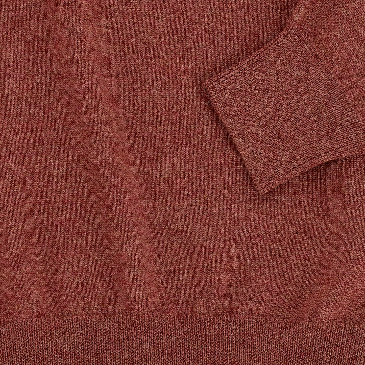 Close-up of the Tom Beckbe York Merino Quarter Zip in rust, made in Italy, showing cuff, hem, and fabric texture.