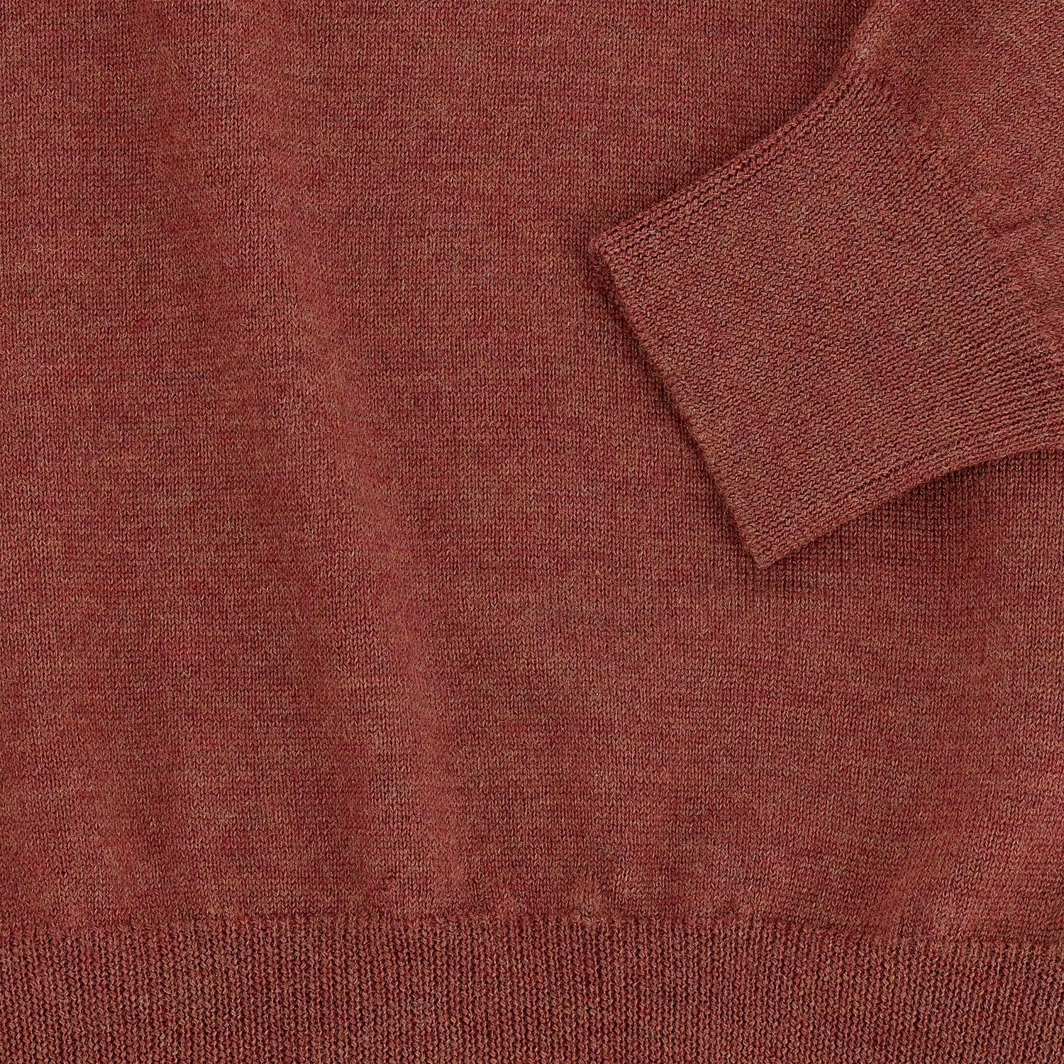 Close-up of the Tom Beckbe York Merino Quarter Zip in rust, made in Italy, showing cuff, hem, and fabric texture.