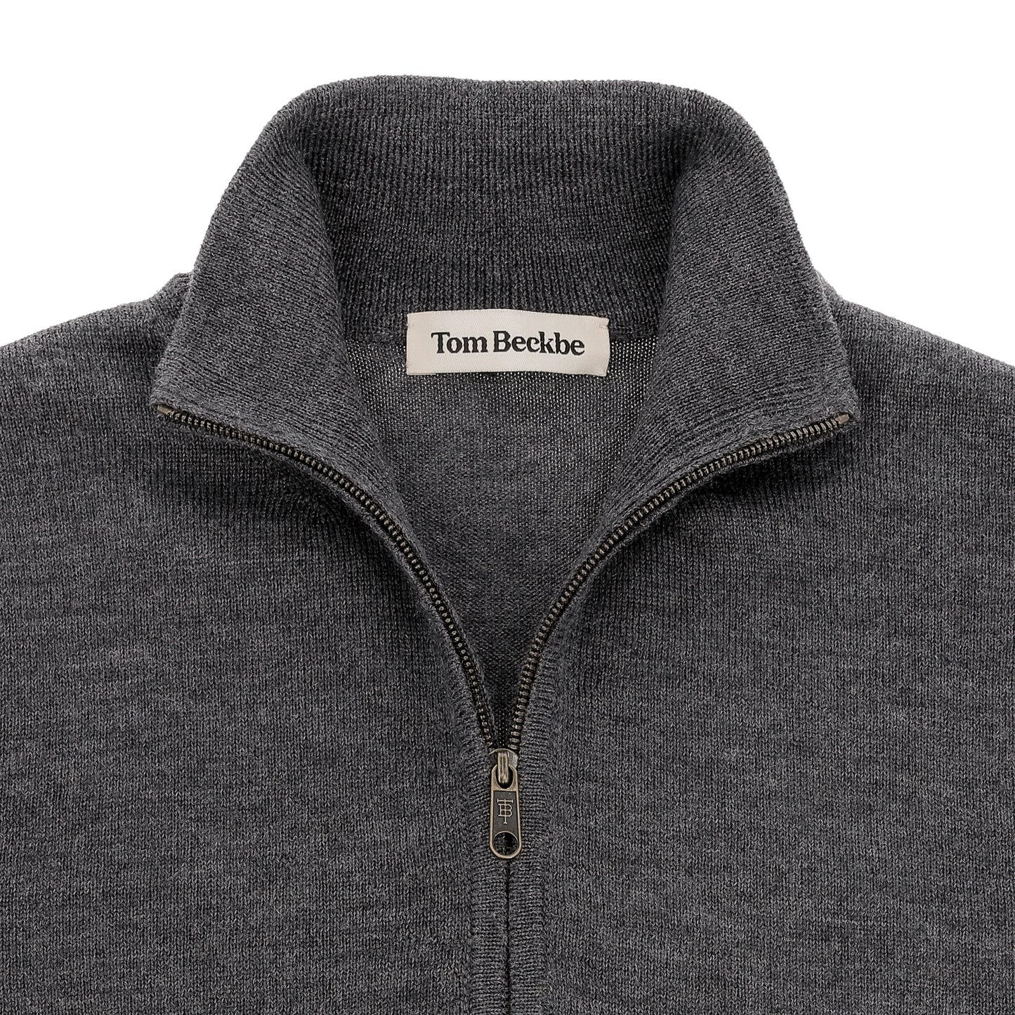 Close-up of a gray Tom Beckbe York Merino Quarter Zip sweater with a standing collar and inner label.