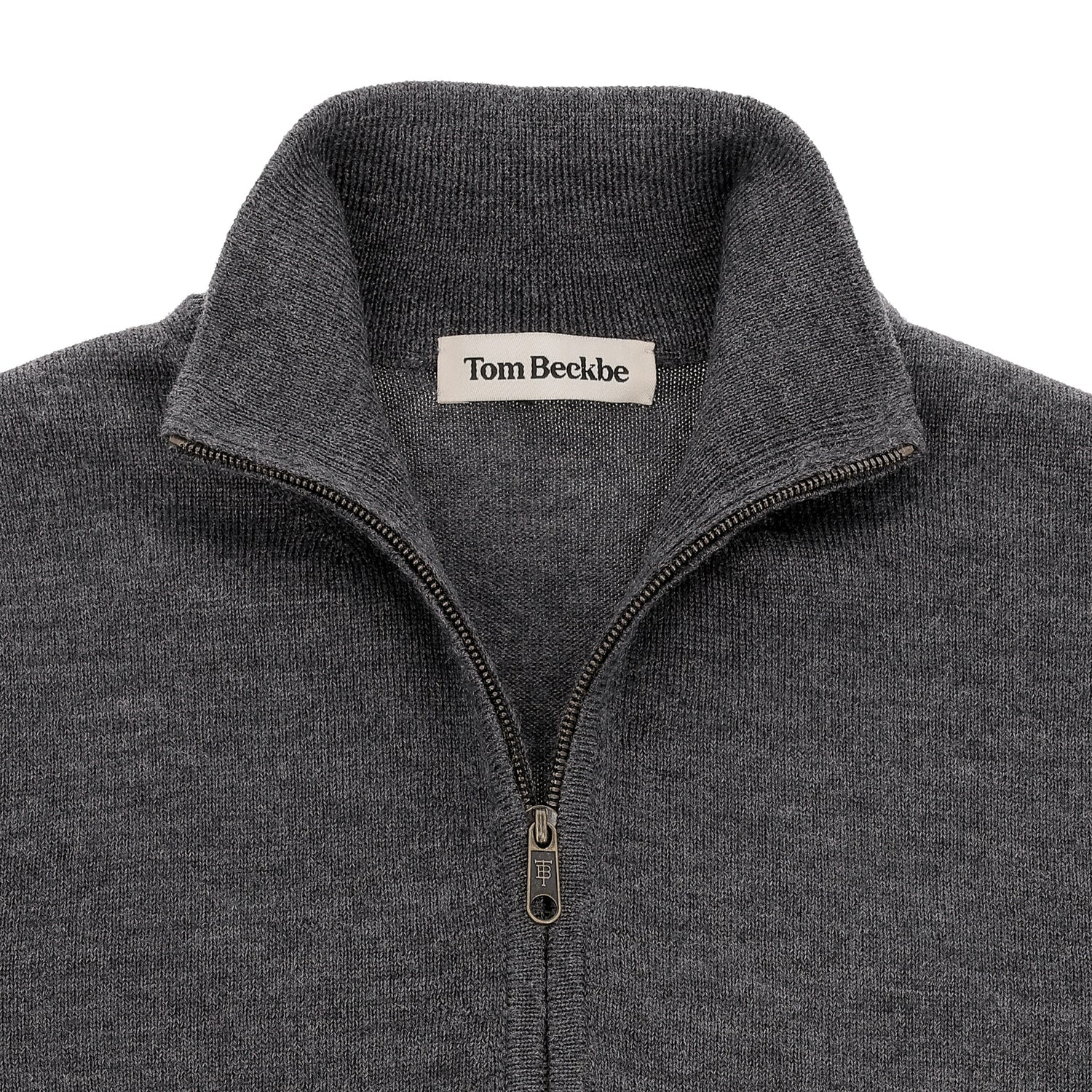 Close-up of a gray Tom Beckbe York Merino Quarter Zip sweater with a standing collar and inner label.