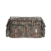 Tom Beckbes Canvas Field Bag in Mossy Oak Original Bottomland has zipper closures, multiple pockets, and brown leather accents.