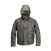 The Tom Beckbe Fowler Jacket in Mossy Oak Original Bottomland features a buttoned front, large pockets, and a high-neck collar.