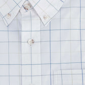 Close-up of the Tom Beckbe Powell Performance Shirt with a blue and beige grid, buttons, collar, and chest pocket.