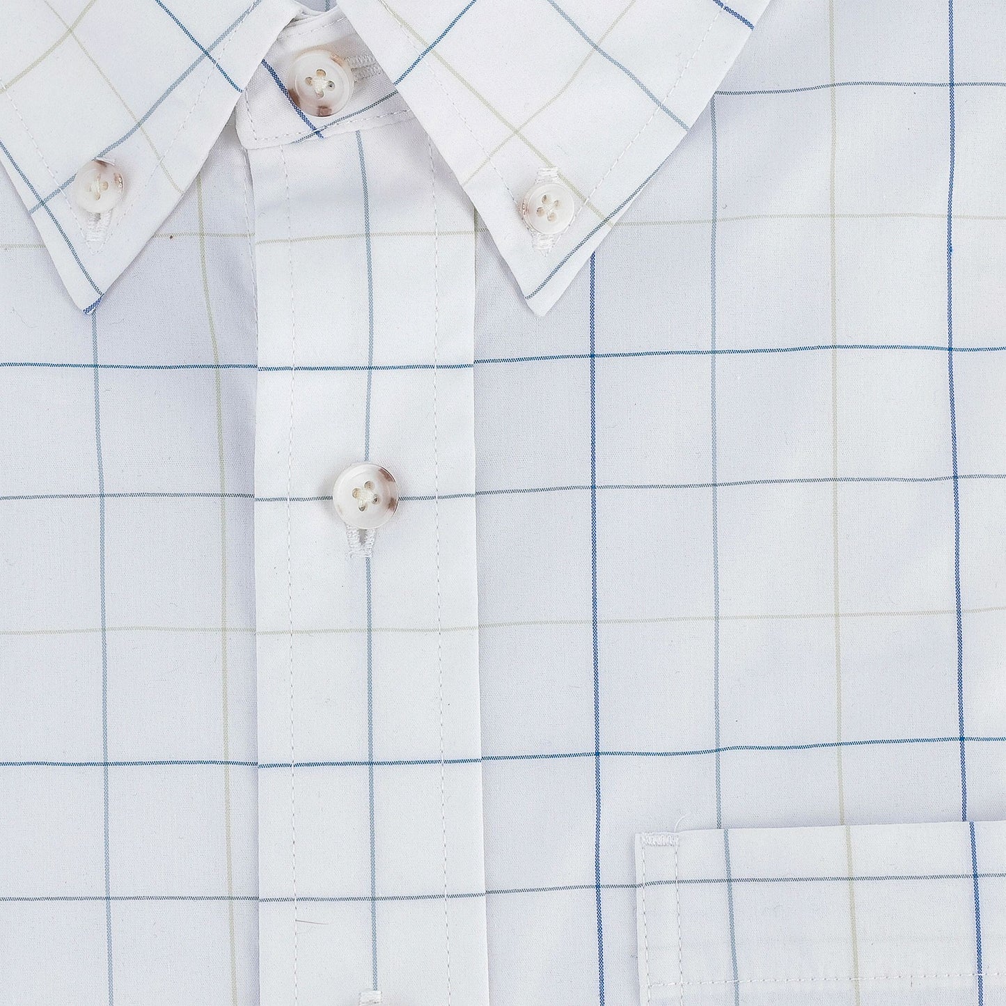 Close-up of the Tom Beckbe Powell Performance Shirt with a blue and beige grid, buttons, collar, and chest pocket.