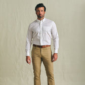Man wearing the Tom Beckbe Powell Performance Shirt with tan pants and a brown belt against a plain background.