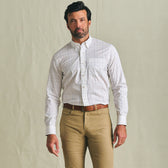 Man wearing a Tom Beckbe Powell Performance Shirt and khaki pants, standing against a plain light-colored background.