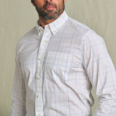 Man wearing the Tom Beckbe Powell Performance Shirt with blue checks and UPF 30+, against a plain background.