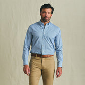 Man wearing Tom Beckbe's Powell Performance Shirt (UPF 30+) and khaki pants against a beige background.