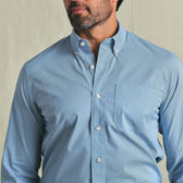 Man wearing the Tom Beckbe Powell Performance Shirt, light blue with chest pocket, shown from shoulders to mid-torso.