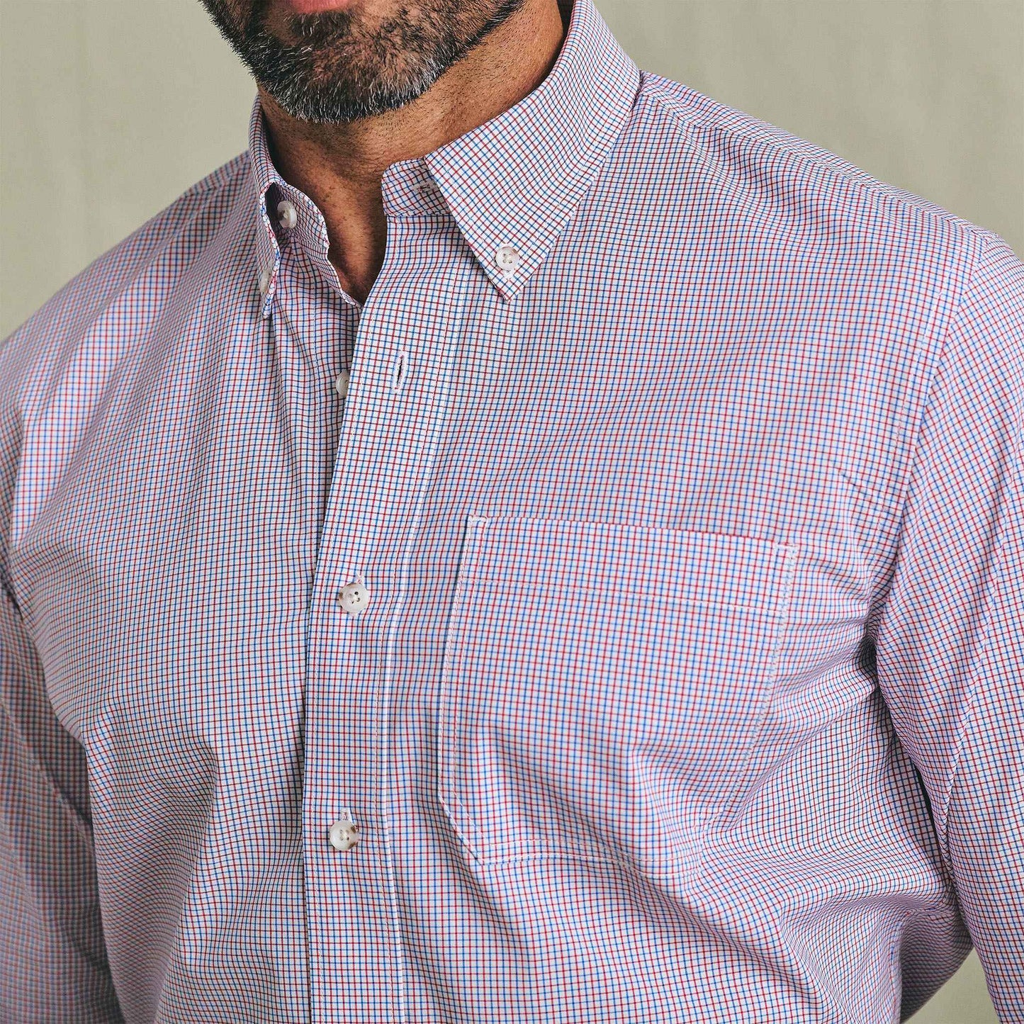 Man wearing Tom Beckbe's Powell Performance Shirt in a blue and red check pattern; upper torso and part of face visible.