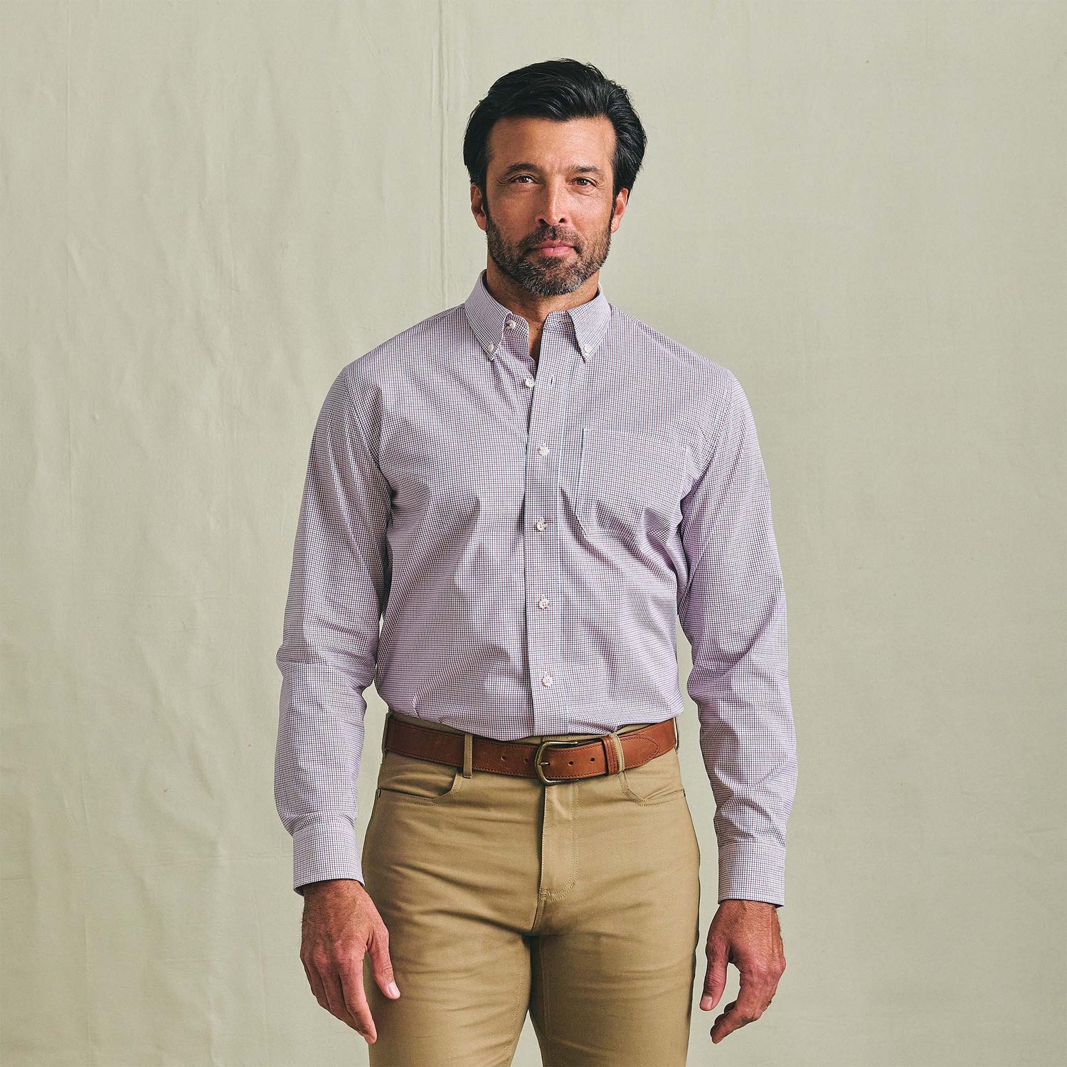 Man facing forward in a Tom Beckbe Powell Performance Shirt with UPF 30+, paired with khaki pants, on a light background.