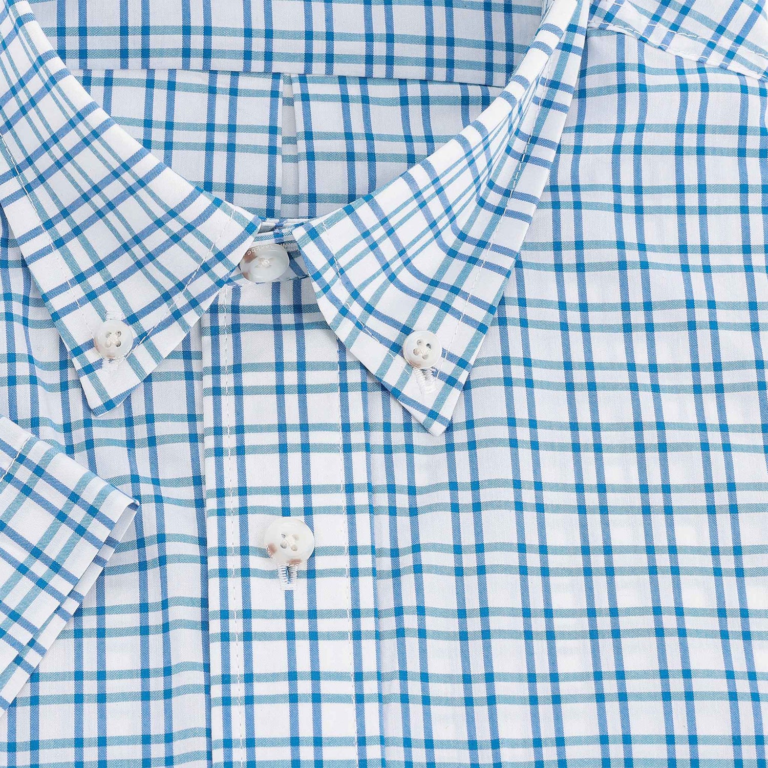 Close-up of the Tom Beckbe Powell Performance Shirt—short sleeve, blue/turquoise plaid, white buttons, UPF 30+.