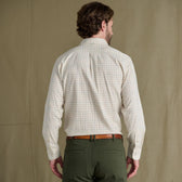 Man faces away wearing Tom Beckbe Prescott Estate Twill Shirt and green pants against a plain background.