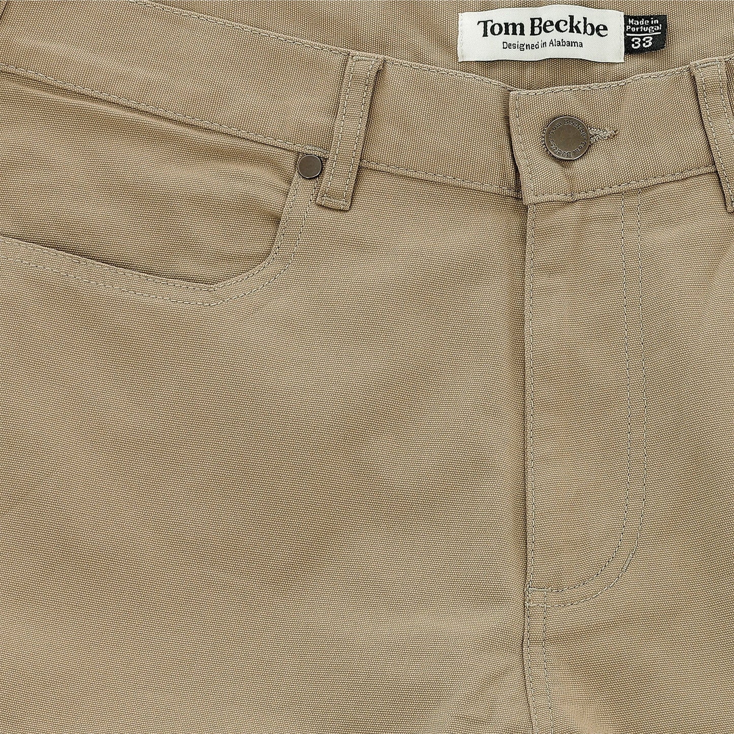 Close-up of Tom Beckbe Reid Straight Leg Cotton Chino Pant in tan with front pocket, belt loop, and button closure.