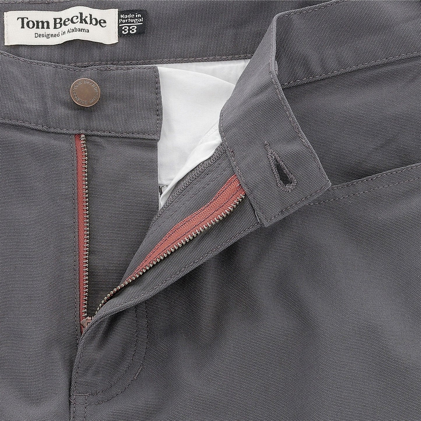 Close-up of gray Reid Straight Leg Cotton Chino Pant for men by Tom Beckbe, zipper open to show inner label.